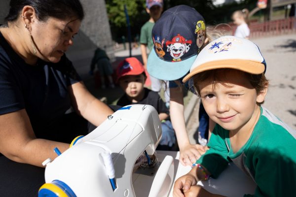 Barnen lär sig sy tillsammans med en pedagog.